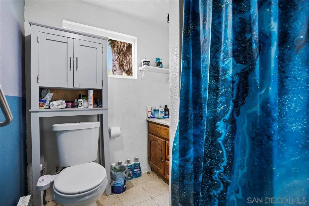 8719 Gardena Road Lakeside, CA 92040 - Photo 31 of 38 a white toilet sitting next to a bathroom sink