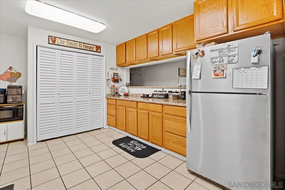 8719 Gardena Road Lakeside, CA 92040 - Photo 8 of 38 a kitchen with stainless steel appliances granite countertop a refrigerator sink and cabinets