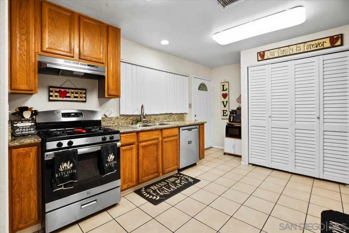 8719 Gardena Road Lakeside, CA 92040 - Photo 9 of 38 a kitchen with stainless steel appliances granite countertop a stove a sink and a refrigerator