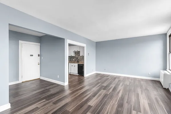 a view of a room with wooden floor