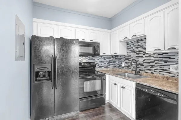 a kitchen with stainless steel appliances granite countertop a refrigerator and a sink