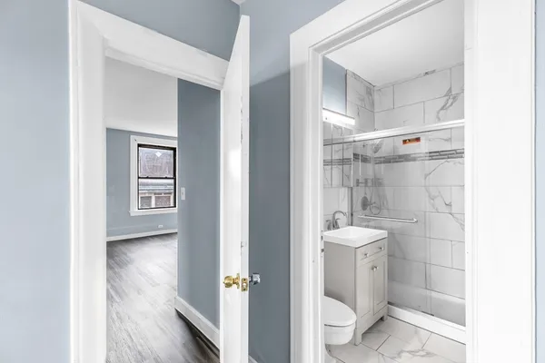 a bathroom with a toilet a sink and shower