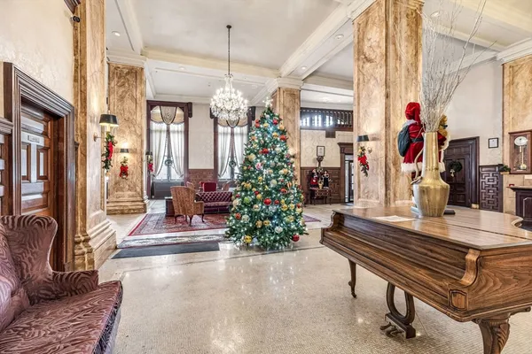 a room with lots of furniture and a chandelier