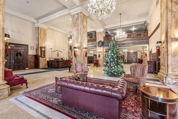 a living room with furniture and a chandelier