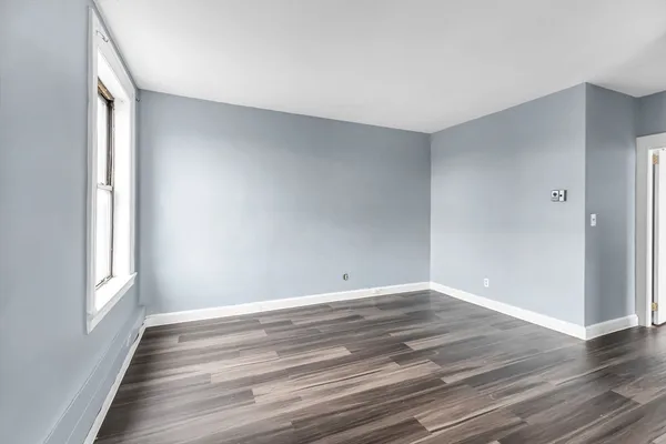 a view of wooden floor and windows in a room