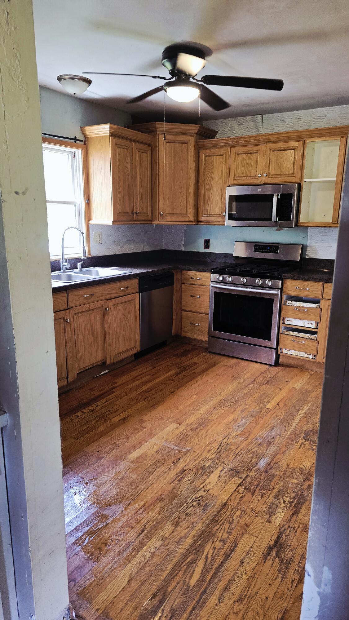 2207 North County Line Road Portage, IN 46368 - Photo 15 of 16 a kitchen with stainless steel appliances kitchen island granite countertop a stove a sink and a microwave