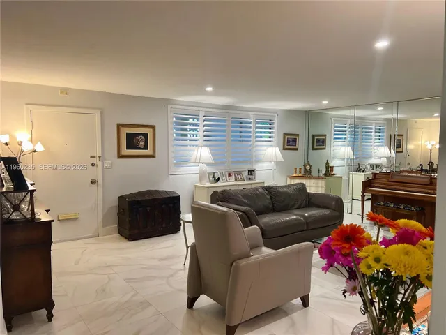 a living room with furniture and a dining table