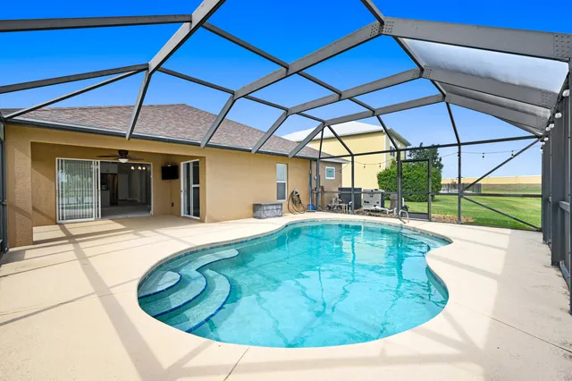 a view of a swimming pool with a yard
