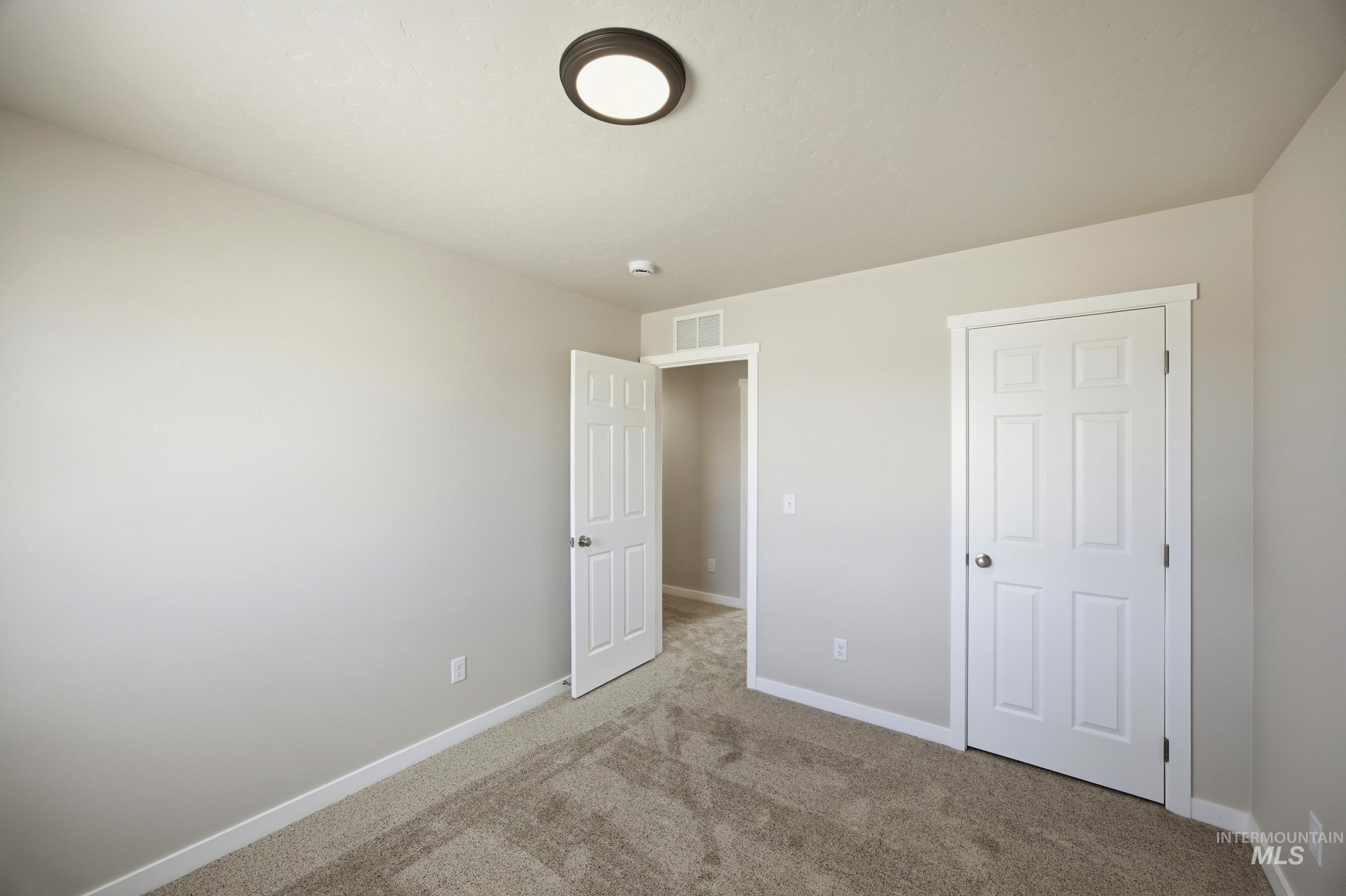 14044 Shiny Spruce Street Caldwell, ID 83607 - Photo 22 of 24 Neutral-toned walls complement plush carpet flooring