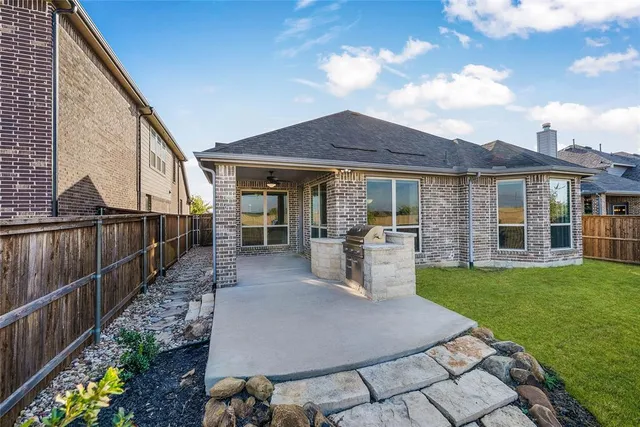 a view of a house with backyard porch and sitting area