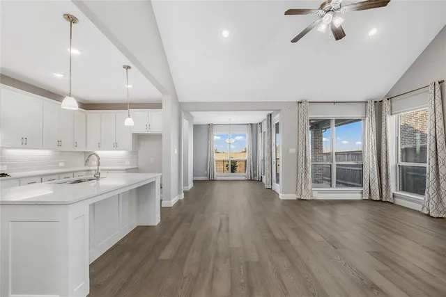a view of a kitchen with a sink and wooden floor