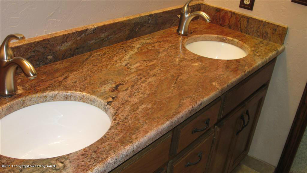 4211 Relatta Avenue Amarillo, TX 79110 - Photo 16 of 41 a bathroom with a granite countertop sink and mirror