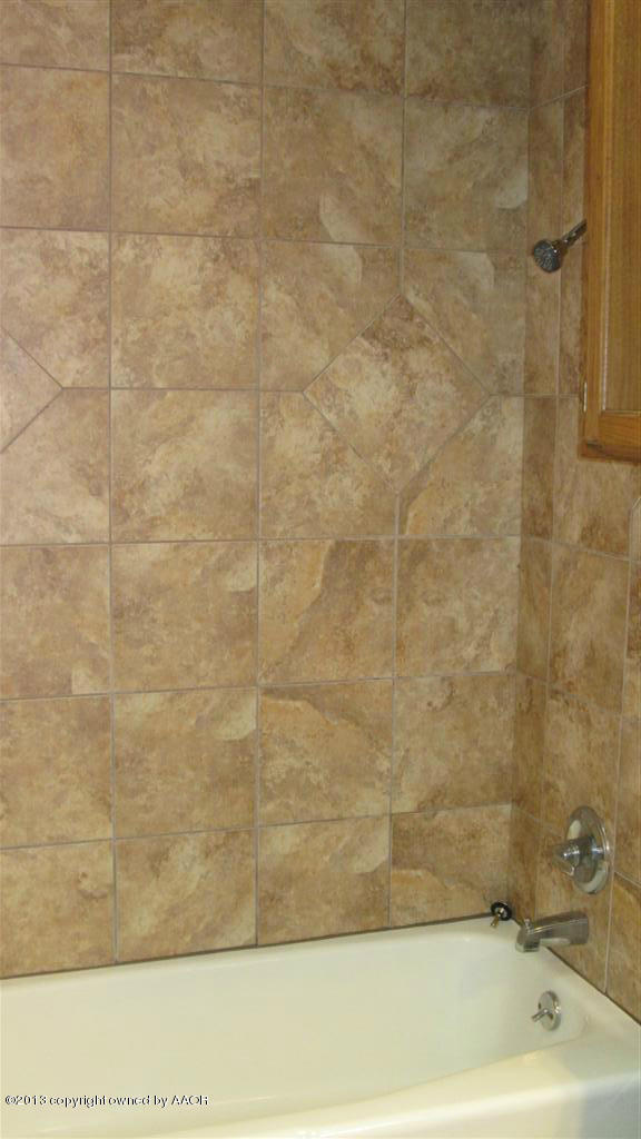 4211 Relatta Avenue Amarillo, TX 79110 - Photo 32 of 41 a bathroom with a bathtub