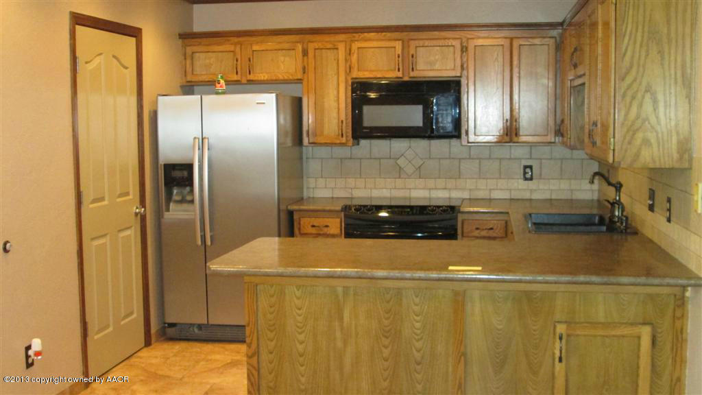 4211 Relatta Avenue Amarillo, TX 79110 - Photo 7 of 41 a bathroom with a sink a mirror and a shower