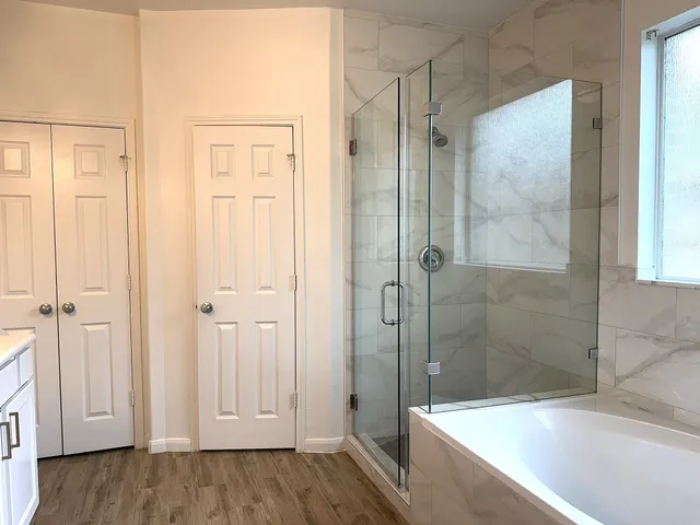 a bathroom with a bathtub and a shower