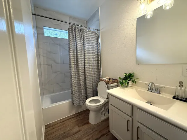 a bathroom with a sink toilet and shower