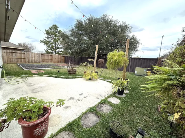 a view of backyard with plants and outdoor seating