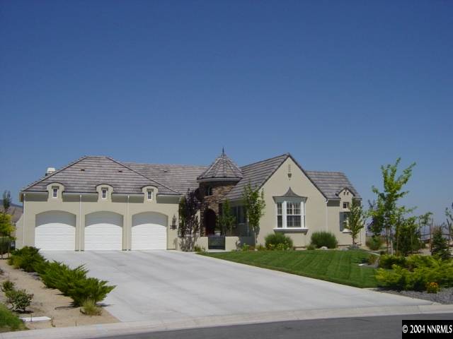2928 Flint Ridge Court Reno, NV 89511 - Photo 1 of 5 a view of a big house with a street and a yard