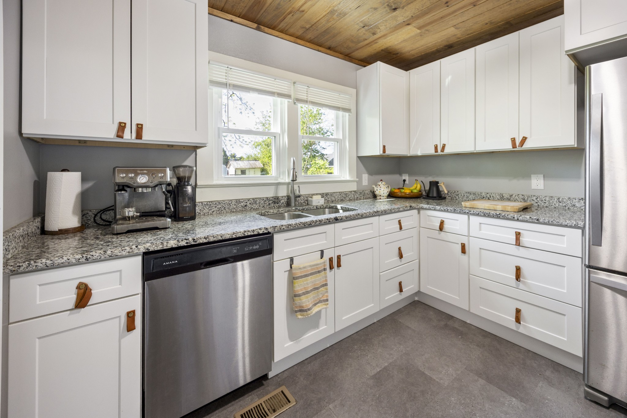 905 Nicholson Street Decherd, TN 37324 - Photo 9 of 27 a kitchen with granite countertop white cabinets white appliances a sink and a window