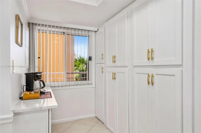 a living room with couches and kitchen view with wooden floor