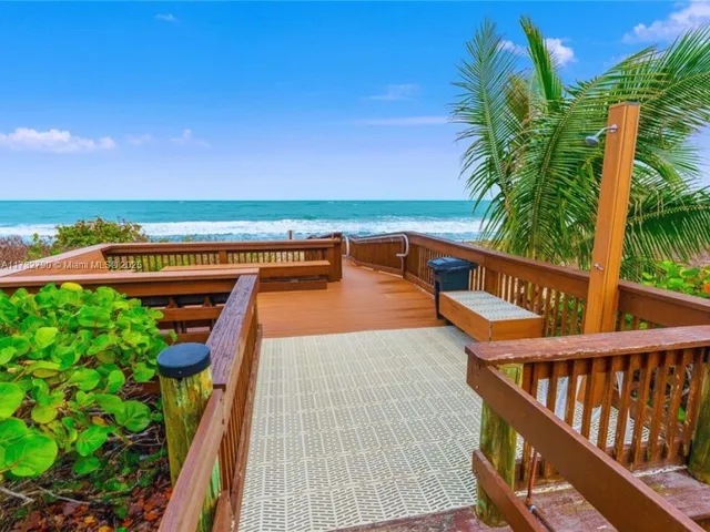 a view of pool with tall buildings and a yard