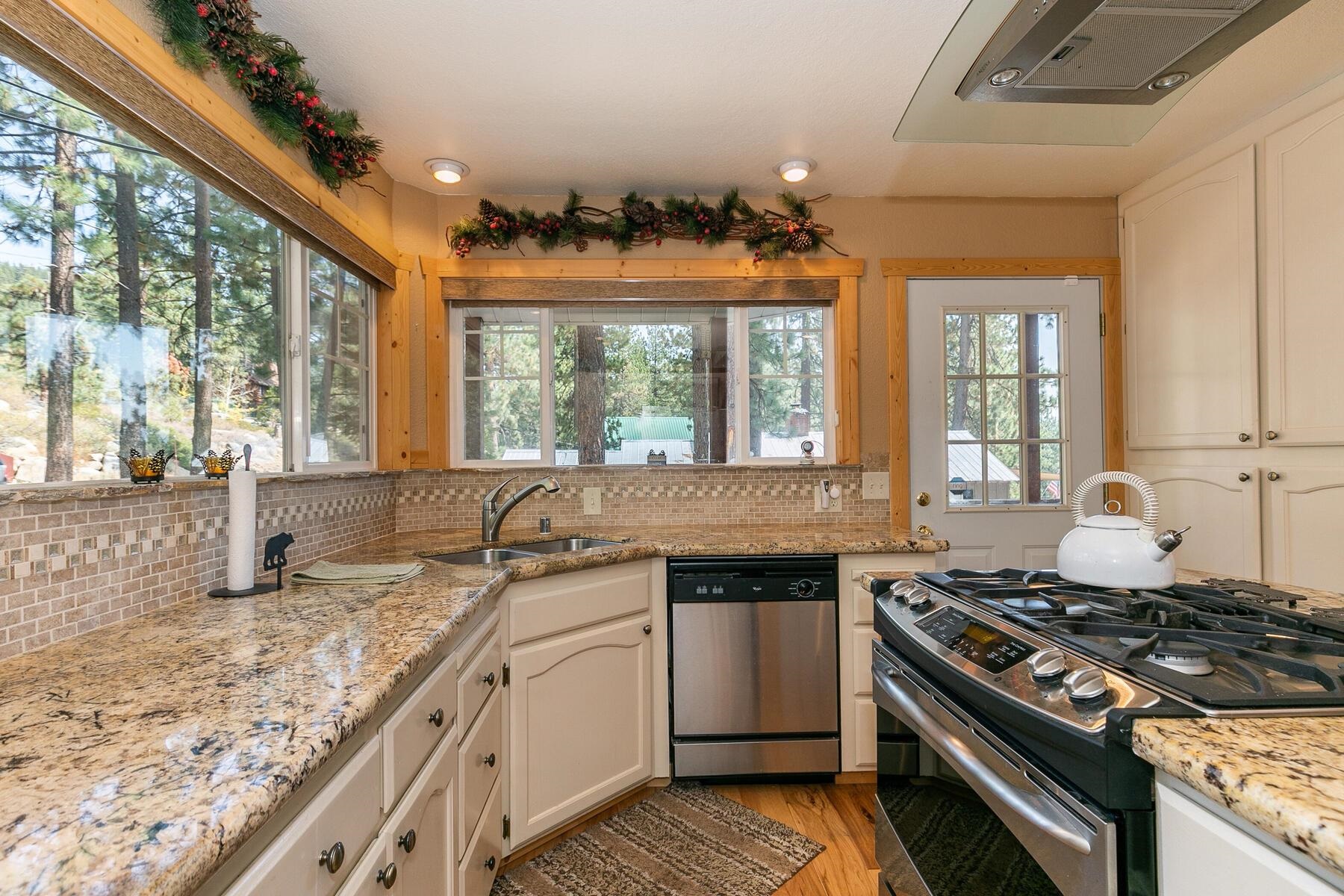 13746 Mogul Way Truckee, CA 96161 - Photo 18 of 21 a kitchen with granite countertop a sink stove and cabinets