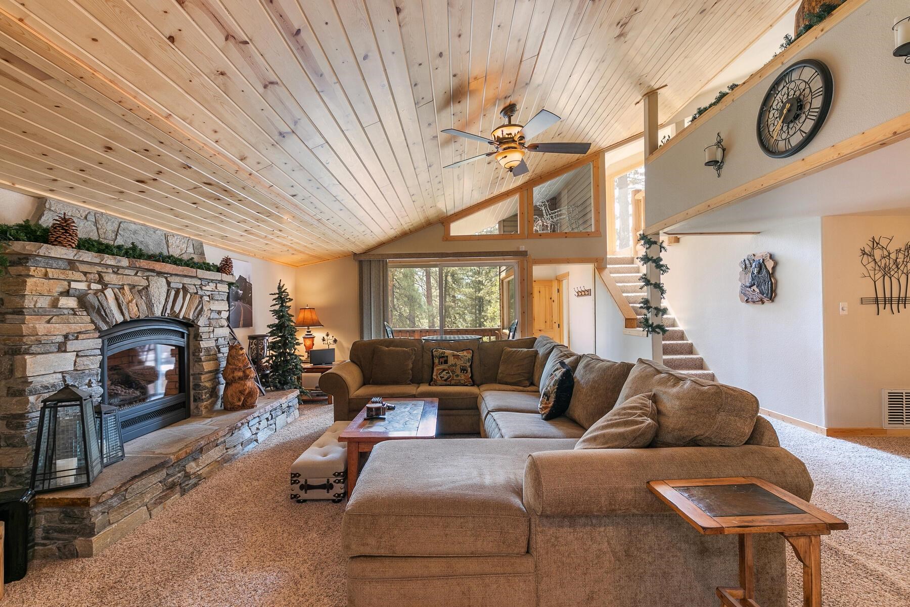 13746 Mogul Way Truckee, CA 96161 - Photo 20 of 21 a living room with furniture a fireplace a clock and a window