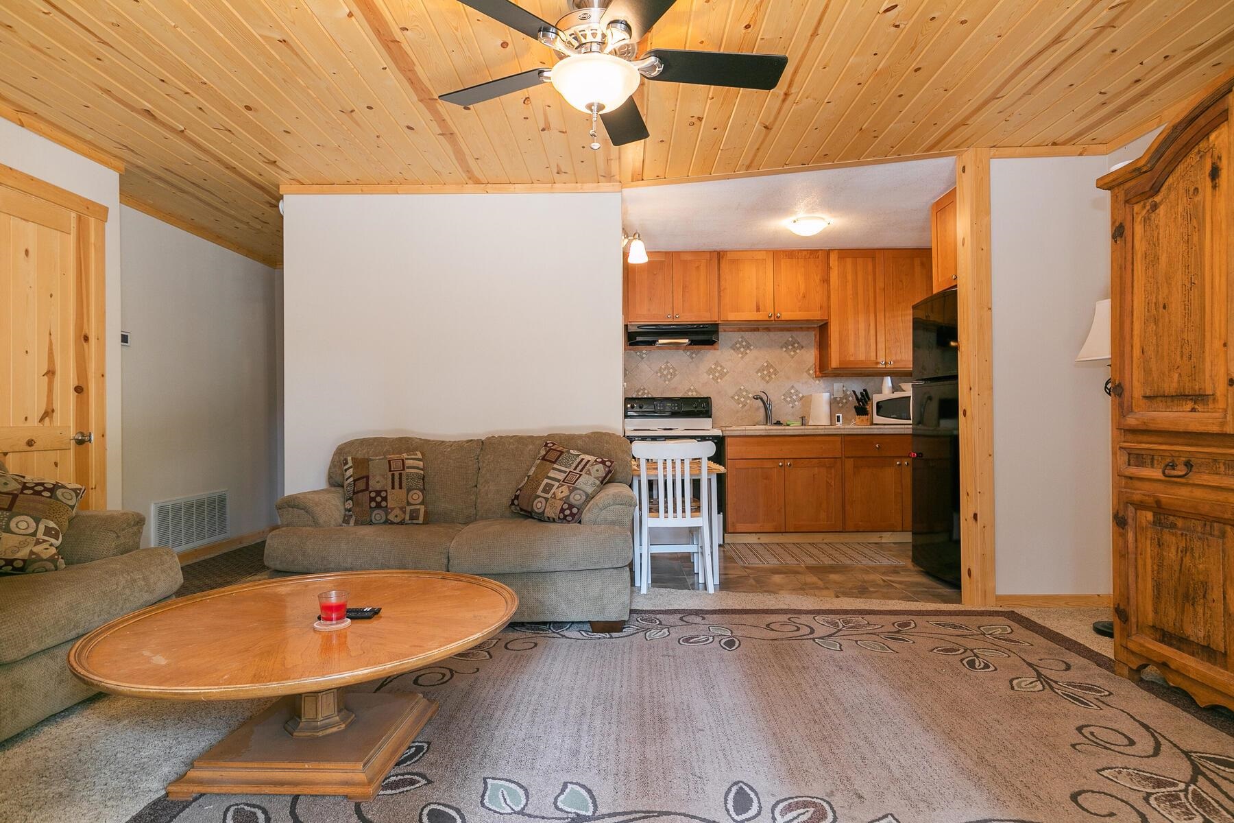 13746 Mogul Way Truckee, CA 96161 - Photo 7 of 21 a living room with fireplace furniture and a floor to ceiling window
