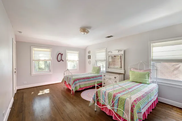 a bedroom with two beds and a window