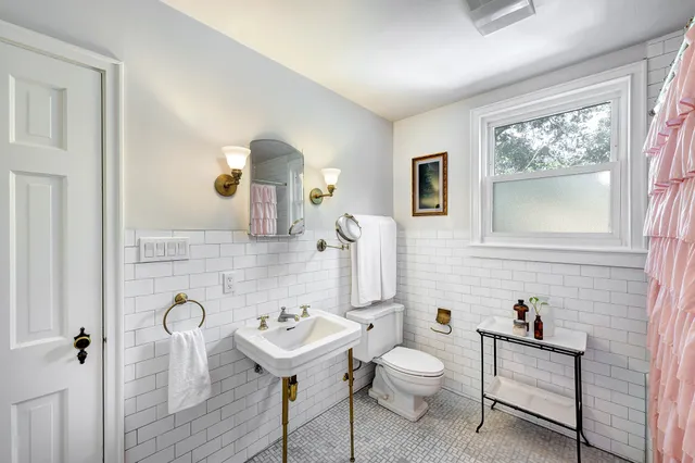 a bathroom with a sink toilet and mirror