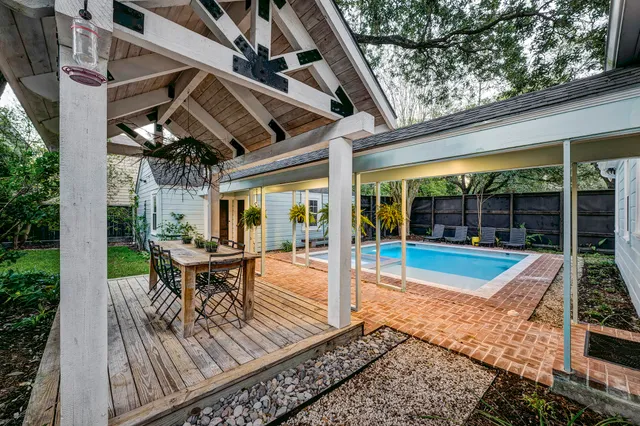 a view of a patio with table and chairs and wooden floor