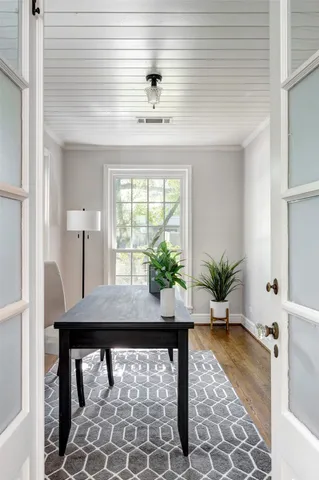 a living room with a table and a potted plant