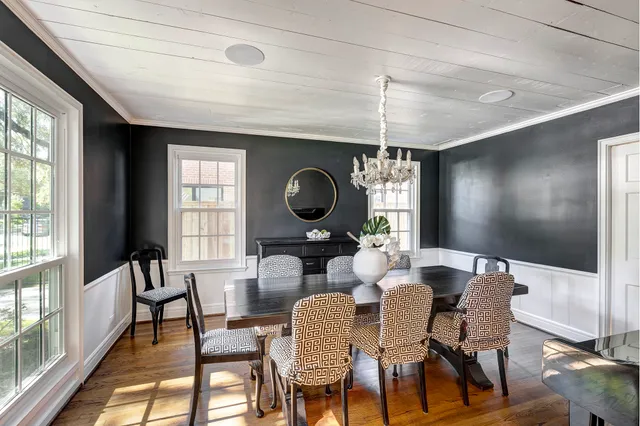 a dining room with furniture a chandelier and window