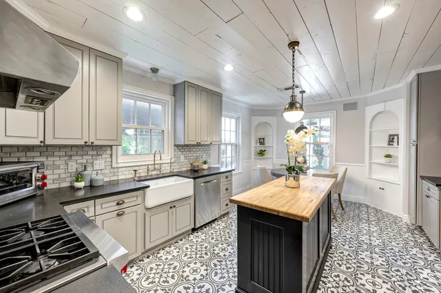 a kitchen with a sink stove and cabinets