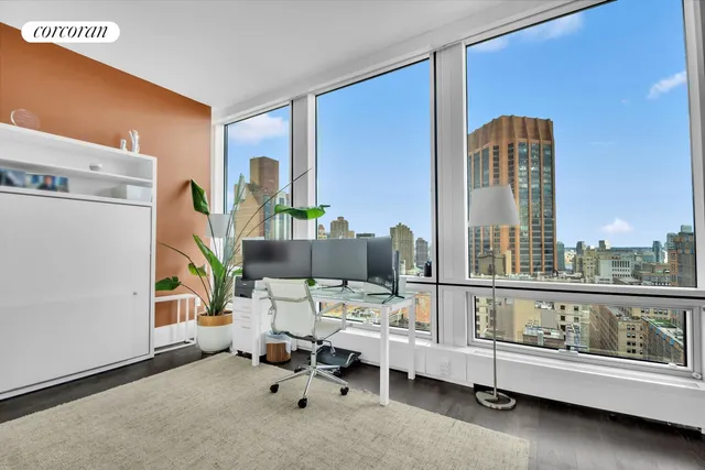 a bedroom with a bed and a large window