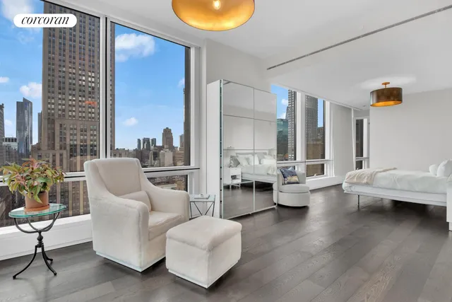 a large white kitchen with a large window and stainless steel appliances