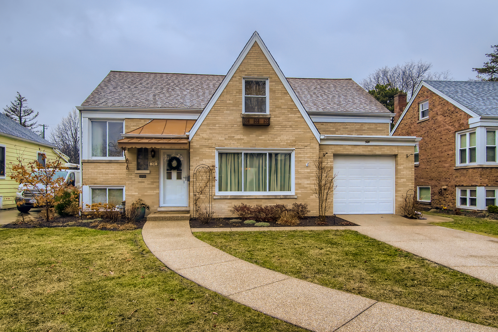 50 Northgate Road Riverside, IL 60546 - Photo 1 of 33 a front view of a house with a yard and garage