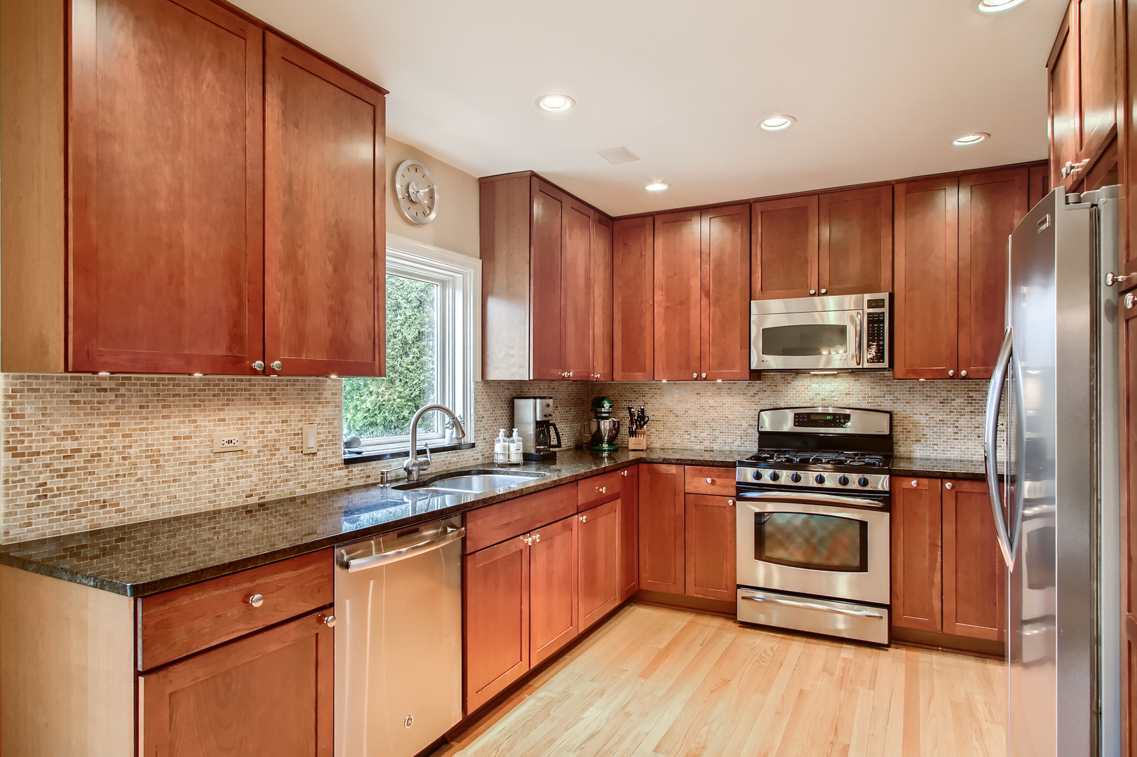 50 Northgate Road Riverside, IL 60546 - Photo 8 of 33 a kitchen with stainless steel appliances granite countertop wooden cabinets a stove top oven with wooden floor