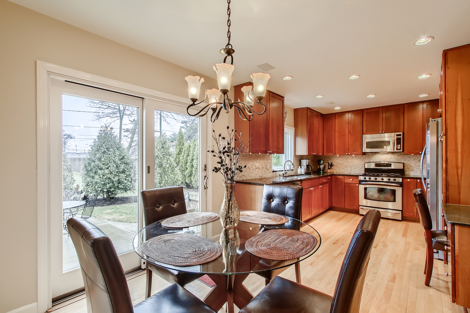 50 Northgate Road Riverside, IL 60546 - Photo 10 of 33 a kitchen with stainless steel appliances granite countertop a stove a refrigerator a kitchen island a table and chairs