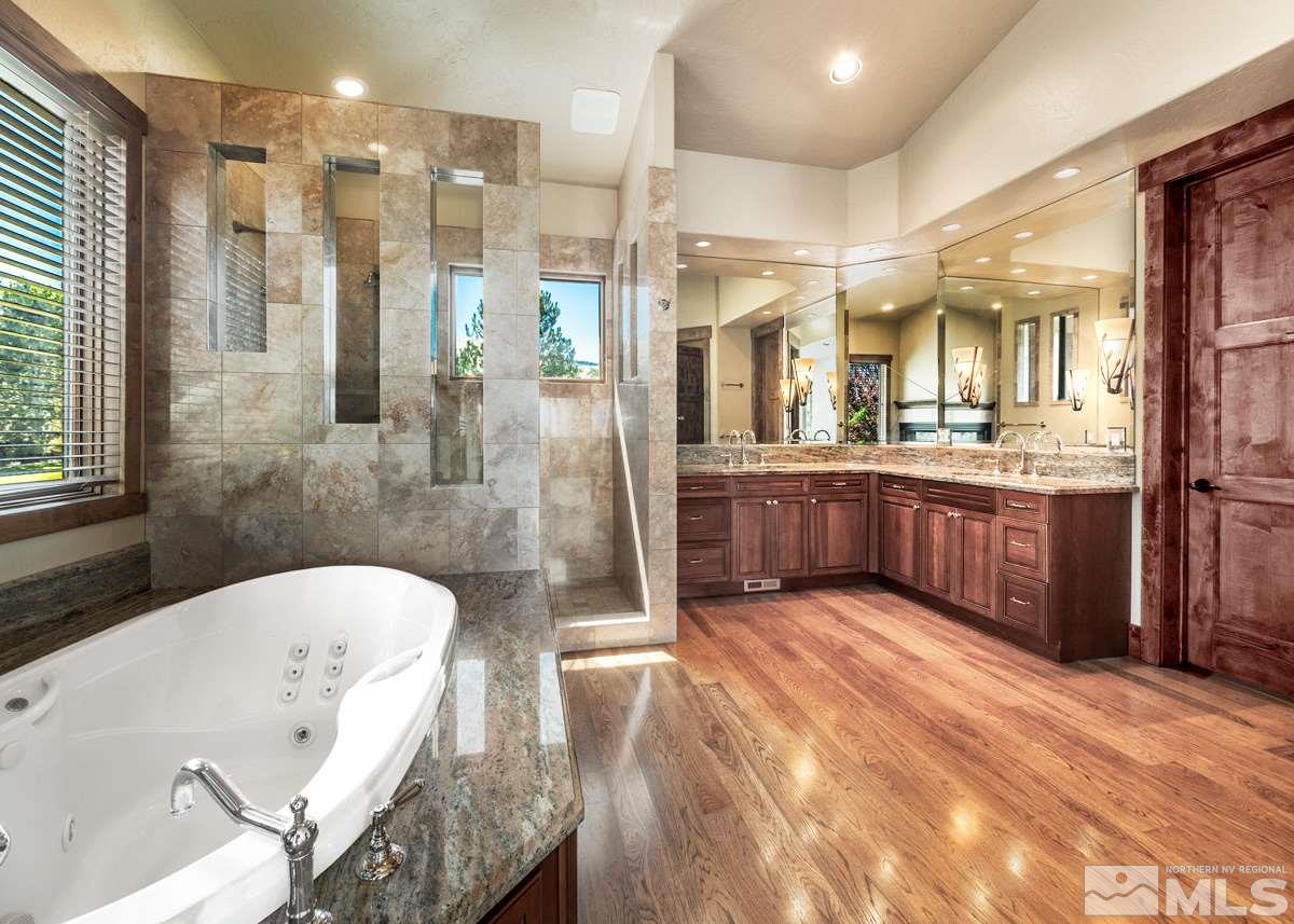4145 Lone Tree Lane Reno, NV 89511 - Photo 12 of 37 a spacious bathroom with a tub sink shower and mirror