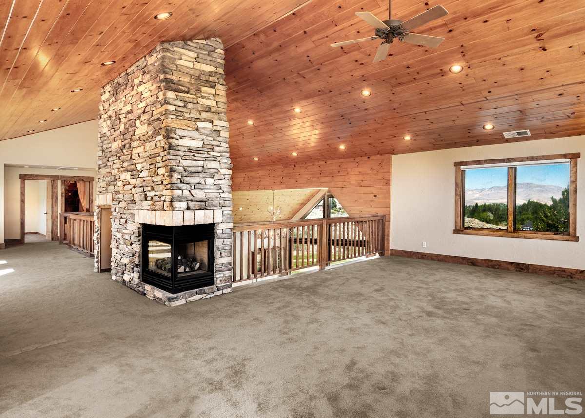 4145 Lone Tree Lane Reno, NV 89511 - Photo 16 of 37 a view of an empty room with a fireplace