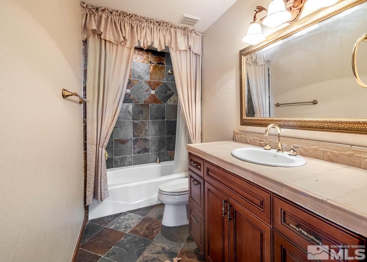 4145 Lone Tree Lane Reno, NV 89511 - Photo 20 of 37 a bathroom with a sink a toilet and shower
