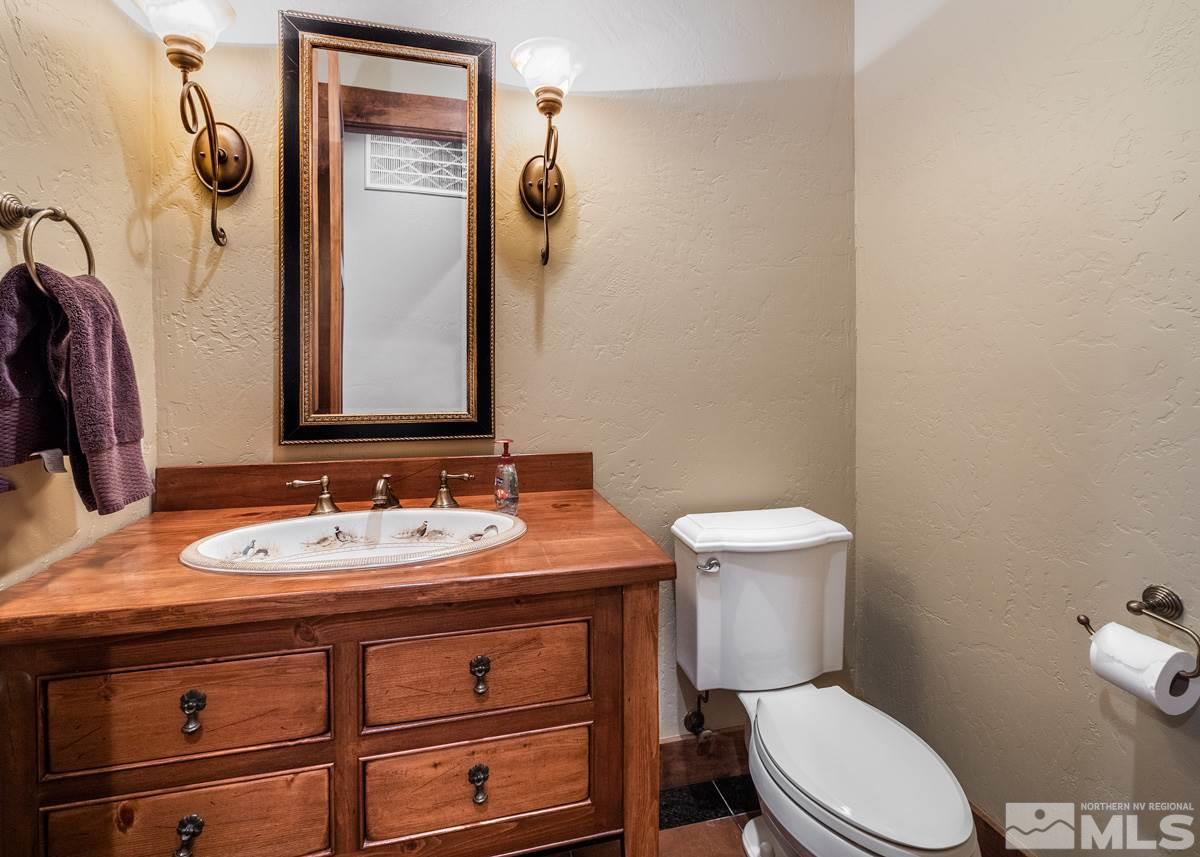 4145 Lone Tree Lane Reno, NV 89511 - Photo 22 of 37 a bathroom with a toilet sink and mirror