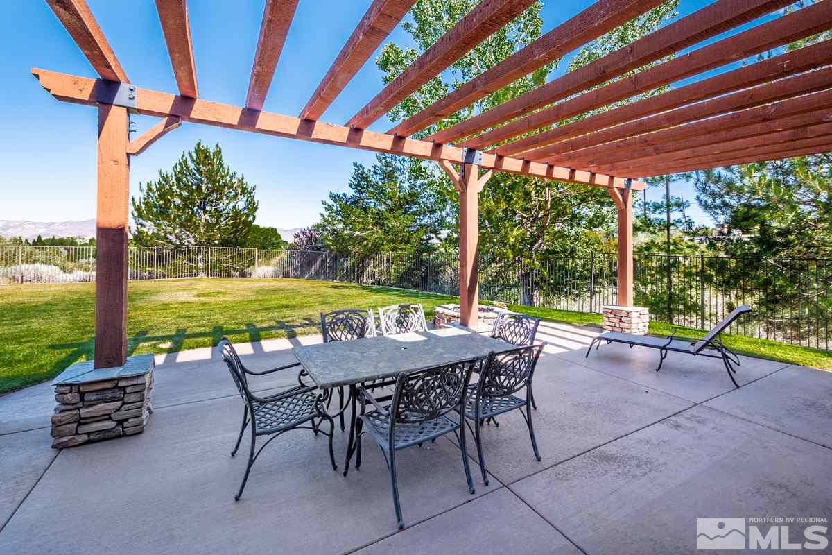 4145 Lone Tree Lane Reno, NV 89511 - Photo 25 of 37 a view of a patio with a table chairs and a backyard