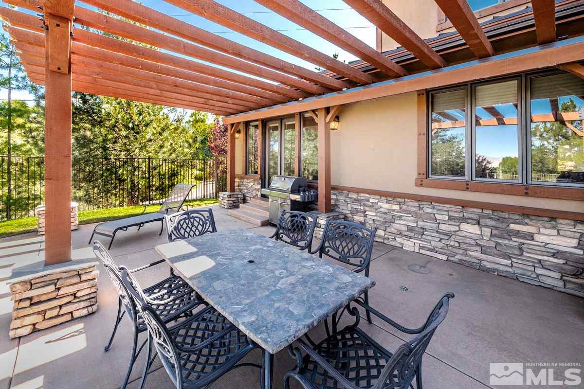 4145 Lone Tree Lane Reno, NV 89511 - Photo 29 of 37 a view of a patio with table and chairs and potted plants
