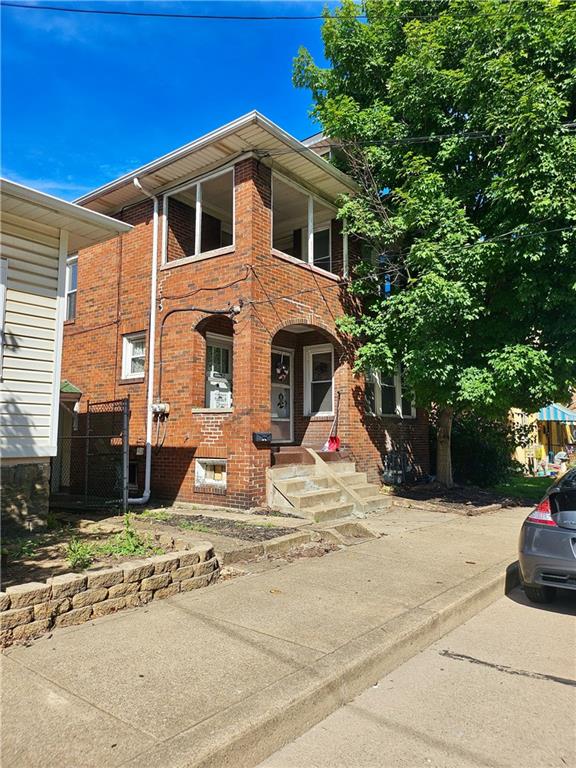 627 5th Avenue, Unit 2 Coraopolis, PA 15108 - Photo 2 of 22 a front view of a house with a yard