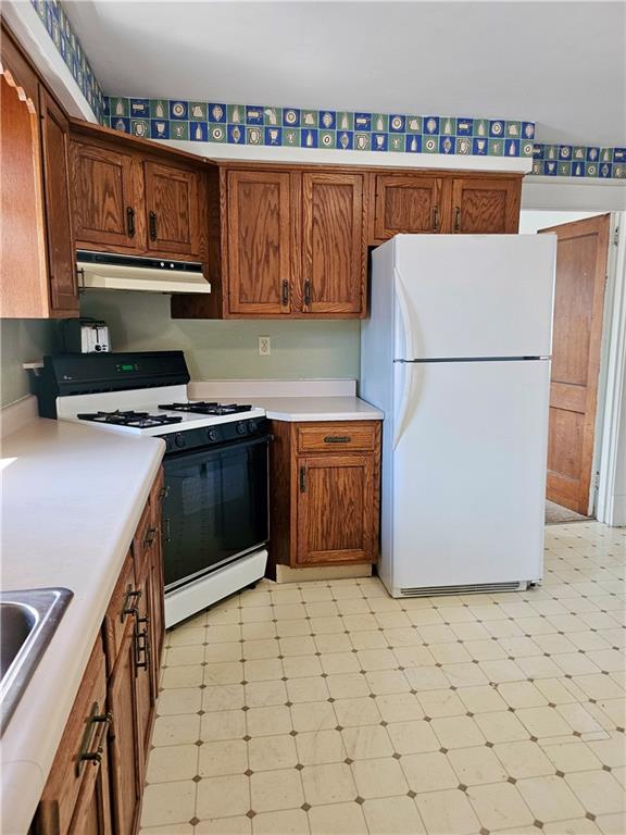 627 5th Avenue, Unit 2 Coraopolis, PA 15108 - Photo 4 of 22 a kitchen with a refrigerator sink and cabinets