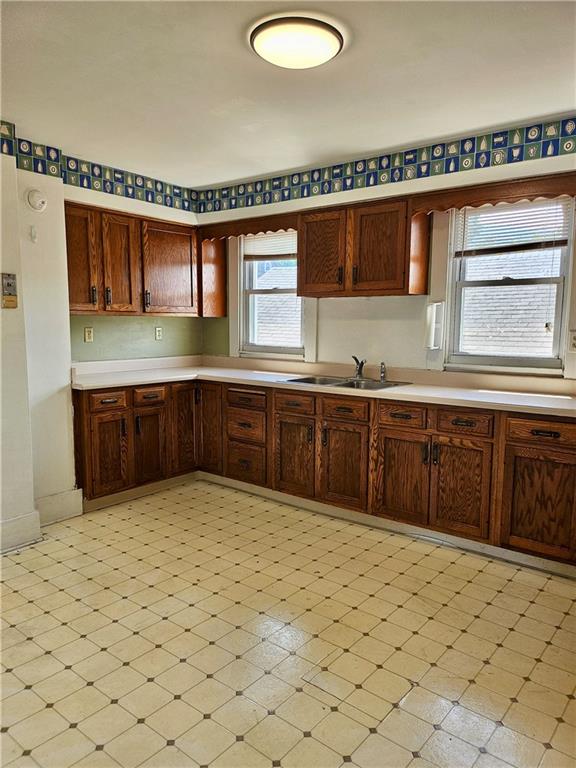 627 5th Avenue, Unit 2 Coraopolis, PA 15108 - Photo 5 of 22 a large kitchen with stainless steel appliances a sink and cabinets