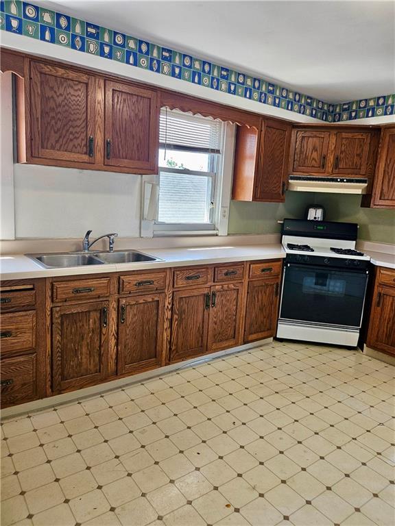 627 5th Avenue, Unit 2 Coraopolis, PA 15108 - Photo 6 of 22 a kitchen with stainless steel appliances a stove a sink and a microwave