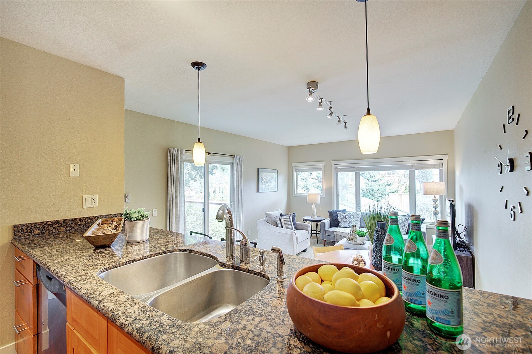 8503 Bowdoin Way, Unit 203 Edmonds, WA 98026 - Photo 9 of 19 a kitchen with a granite countertop sink a stove and a wooden floor